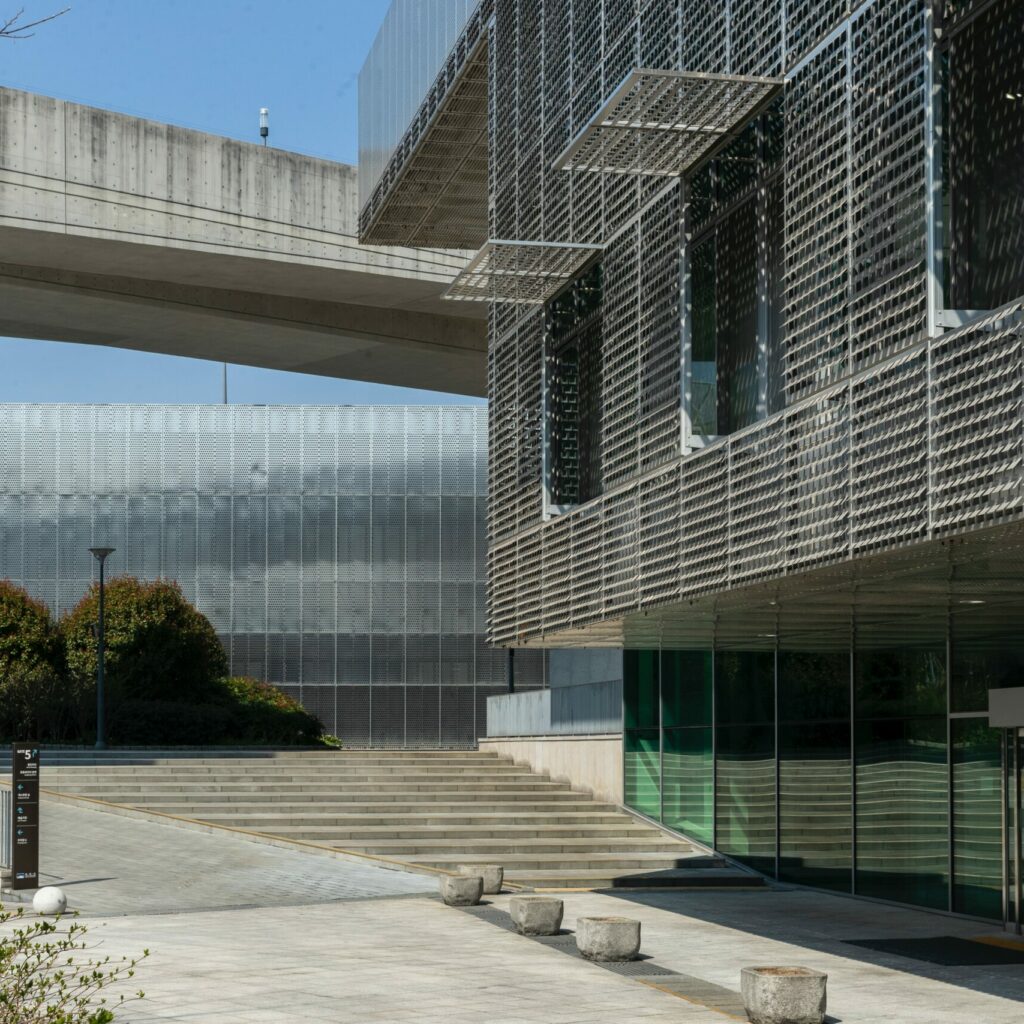 white concrete building near green trees during daytime